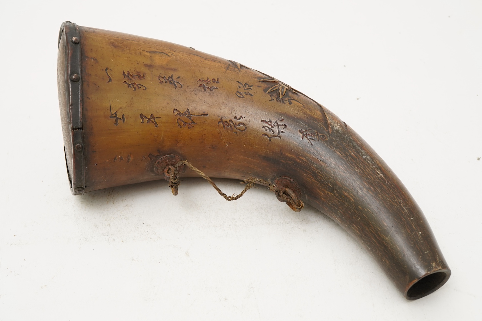 A Tibetan or Mongolian inscribed buffalo horn powder flask, 18th century